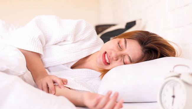 Woman grinding her teeth during sleep