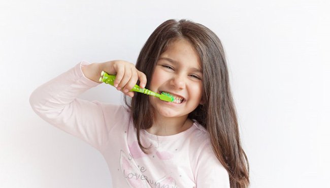 Young girl brushing her teeth